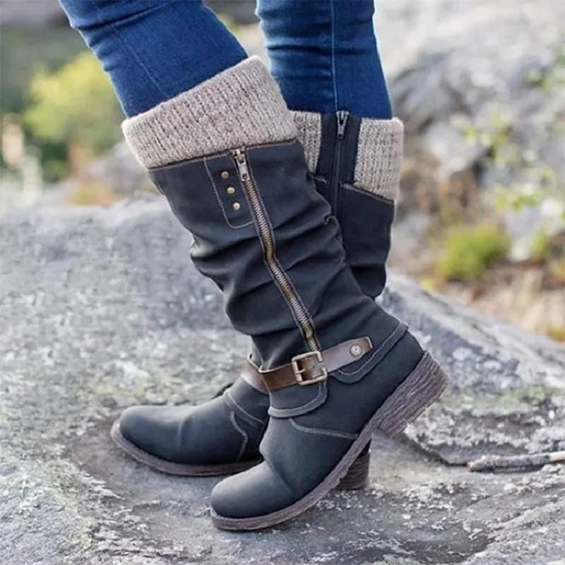 Getragener schwarzer Kniestiefel mit Strickmanschette und Schnalle