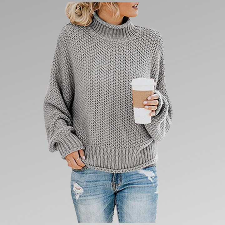 Grauer Strickpullover mit Rollkragen und locker geschnittenen Ärmeln