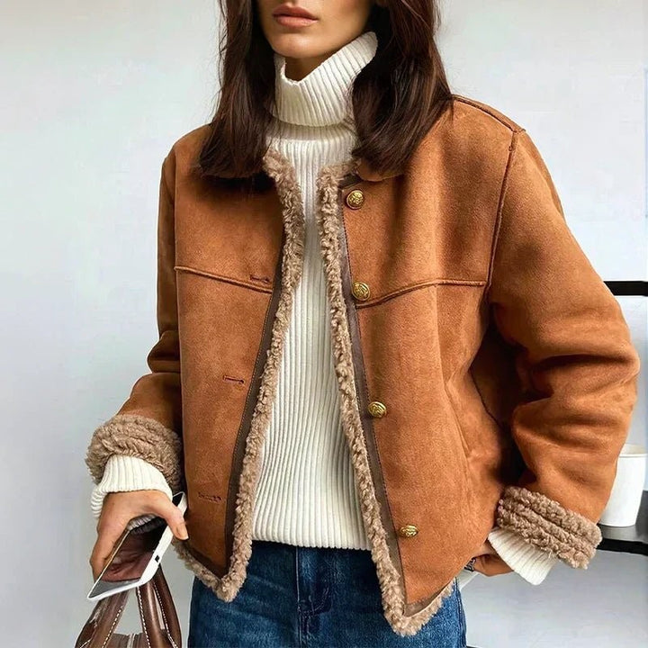 Cognacfarbene Sherpa-Jacke kombiniert mit weißem Rollkragenpullover und Jeans