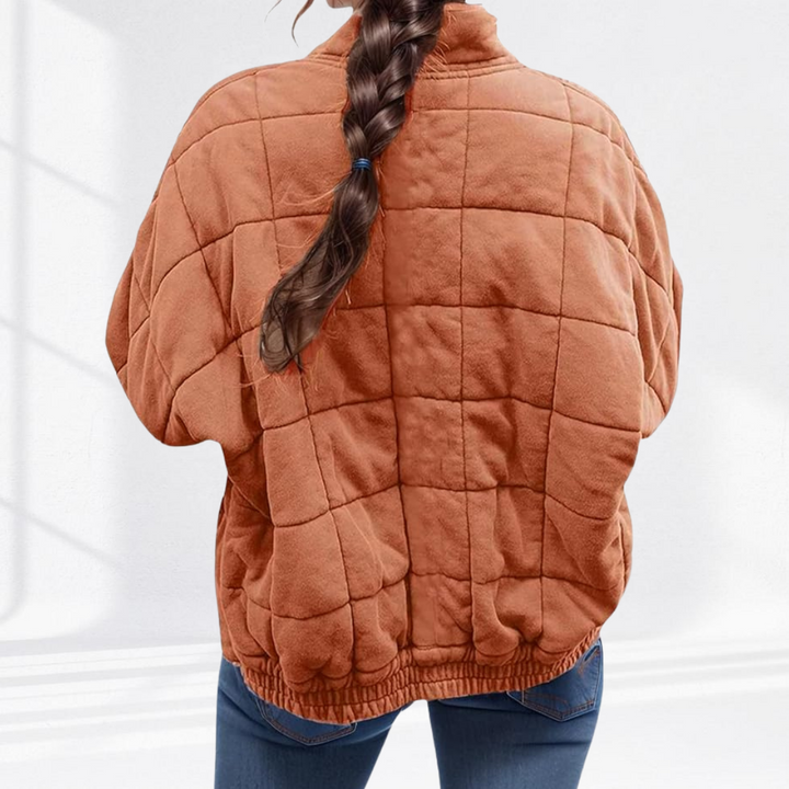 Terrakottafarbene Steppjacke von hinten mit Rautenmuster und Zopffrisur