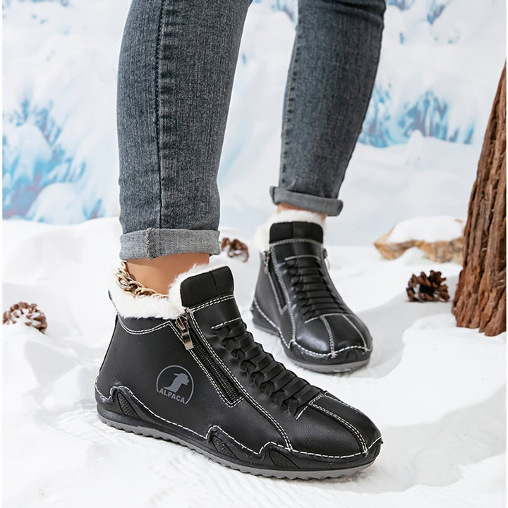 Schwarze gefütterte Ankle Boots mit Schnürung in winterlicher Schneelandschaft