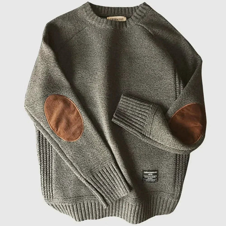 Grauer Strickpullover meliert mit braunen Ellbogenpatches und Rippbündchen