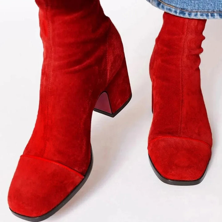 Rote Wildleder Stiefeletten mit Blockabsatz, vorne getragen mit Jeans